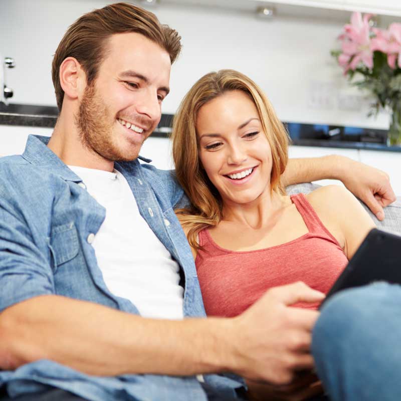 Happy couple looking at computer screen together